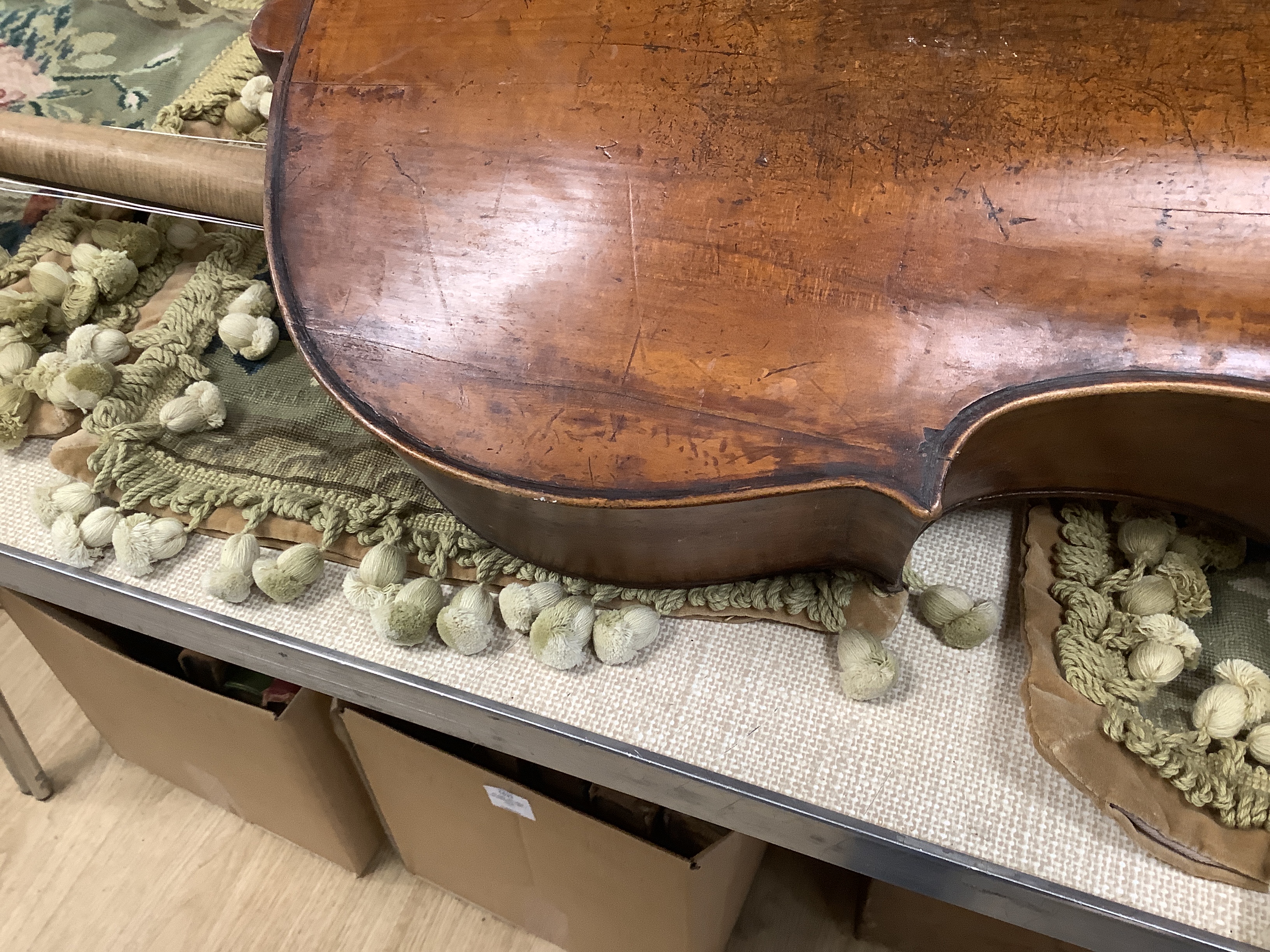 An early 20th century cello for restoration, indistinct internal label; ‘Restored by William J. Acton, Green Street, Forest Gate, London 1910’ length of body 72cm.